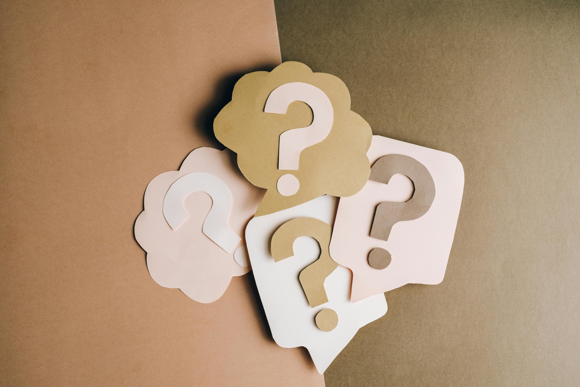 Paper speech bubbles with question marks